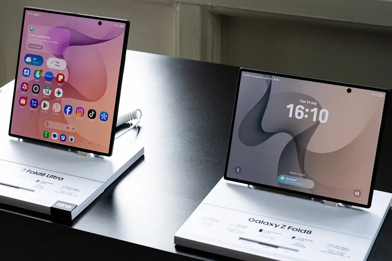 Samsung Galaxy Z Fold8 Ultra (left) and Galaxy Z Fold8 (right) unfolded on labelled display stands