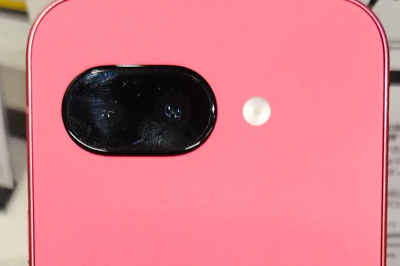 Close-up of the back of a pink Google Pixel 9a and its camera bar